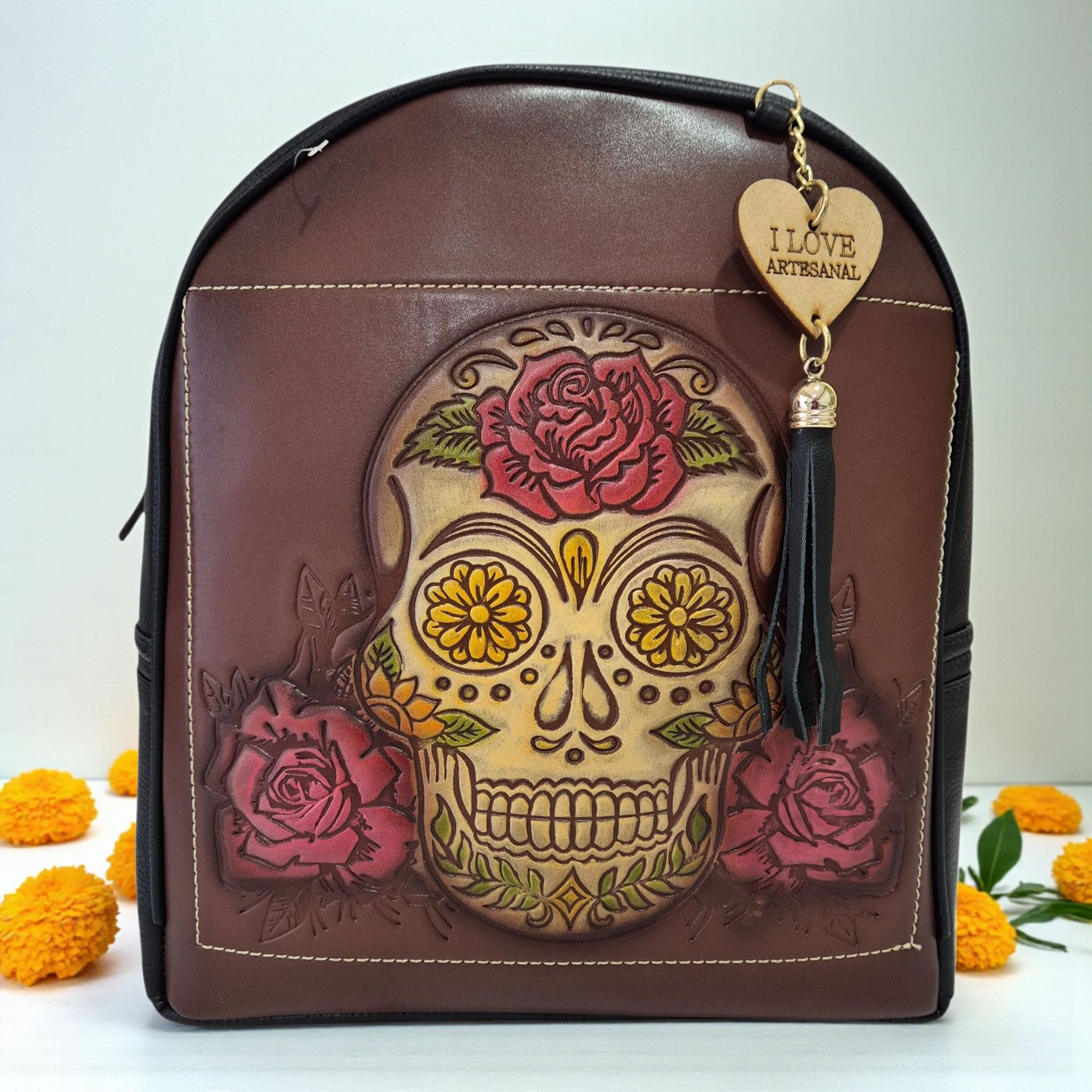 Handmade brown and black backpack engraved with a skull and flowers in – Meraki Nogales