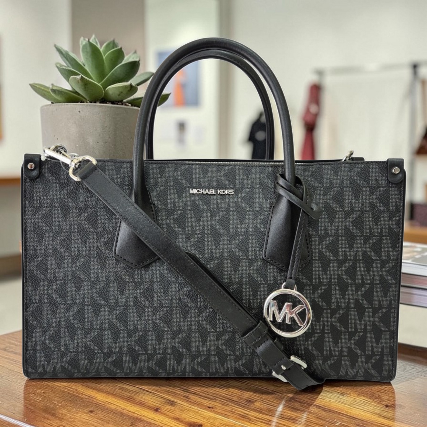 Bolsa Michael Kors negra tipo tote con logo MK y correa ajustable