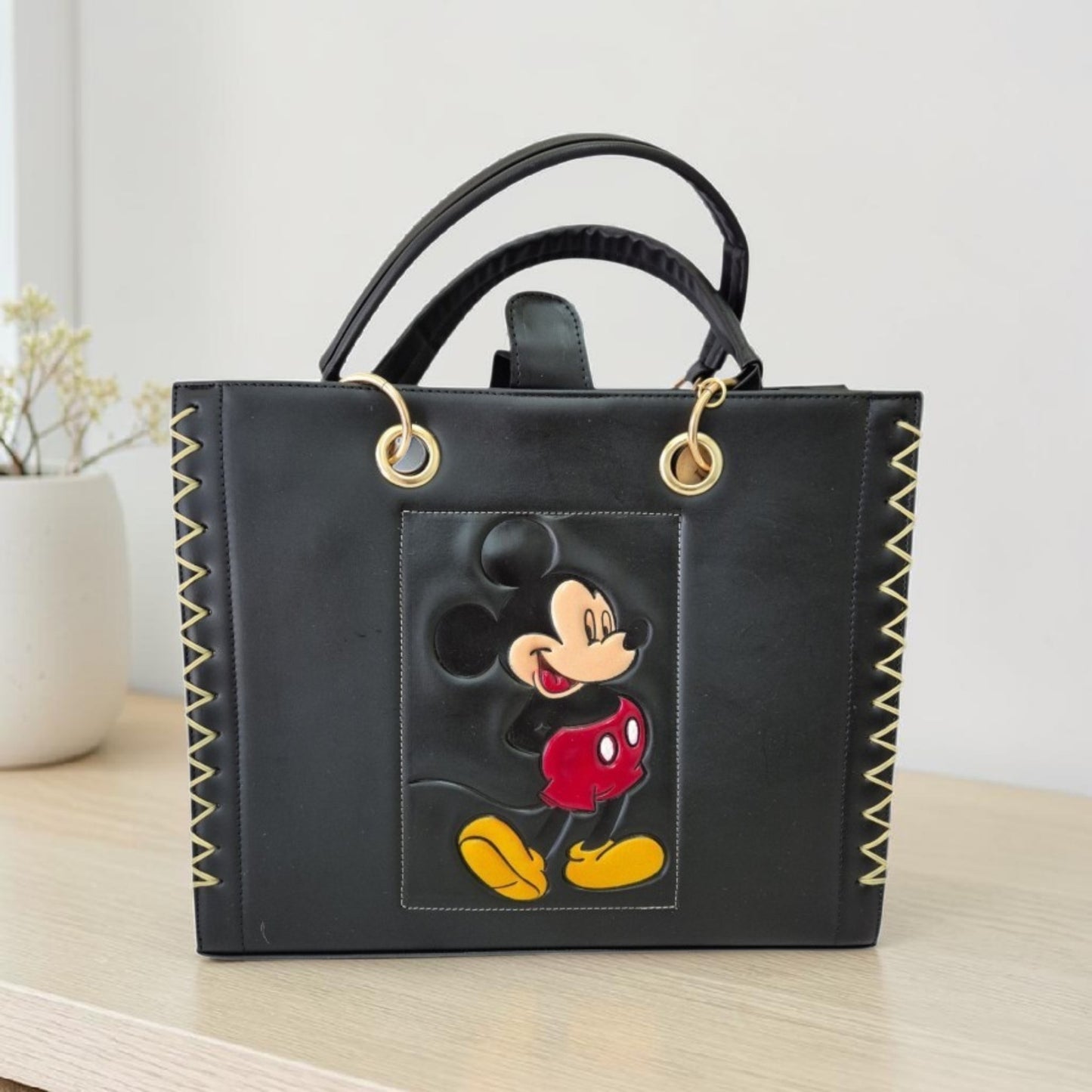 Handmade bag with a unique design. Includes a cosmetic bag, short handles, and an adjustable long strap.
